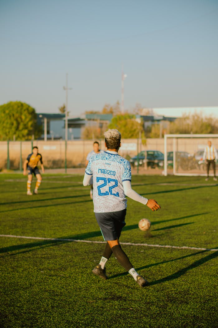 Dynamic soccer game on a sunny day with players in action, focusing on teamwork and sports spirit.
